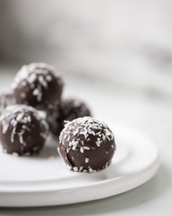 Petit fours mini pastries on white marble background with copy space