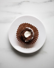 Petit fours mini pastries on white marble background with copy space