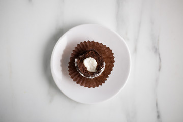 Petit fours mini pastries on white marble background with copy space
