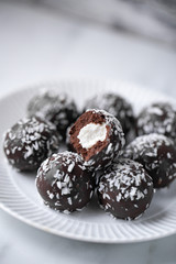 Petit fours mini pastries on white marble background with copy space