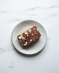 German Chocolate Cake with a Coconut Icing on marble background with copy space