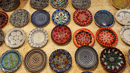 Hittite wine vessels, colorful ceramic vases and porcelain bowls in a underground cave atelier in Avanos in Cappadocia. Turkish traditional ceramic handycrafts in a local pottery shop in Cappadocia