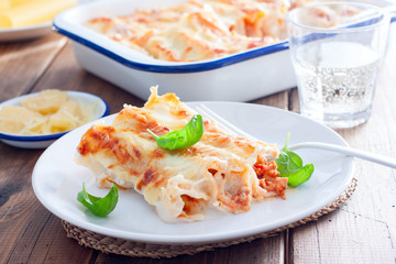 Baked cannelloni with minced meat with bechamel sauce, selective focus