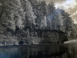 Fototapeta na wymiar infrared photo: landscape with river, and amazing beautiful trees and glare