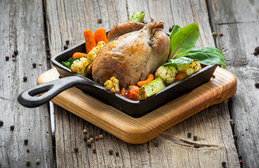 Grilled pheasant with bacon and spices and vegetables