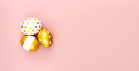 Fototapeta na wymiar Trendy white golden spring easter eggs flat lay on colorful pink background top view with copy space. Hand painted eggs. Happy easter day celebration concept. Web banner template. Stock photo.