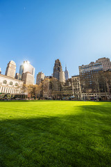 Fototapeta na wymiar Green Lawn and Skyline with Skyscrapers in Bryant Park NYC