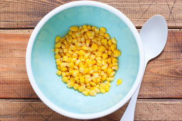 Step by step cooking salad with canned tuna and corn, step 2 - adding corn, top view, horizontal