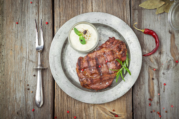 Tenderloin steak on plate with sauce