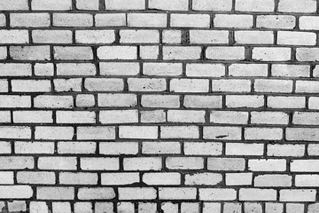Texture of a brick wall with cracks and scratches which can be used as a background
