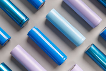 Close up of colorful used rechargeable Nickel Metal Hydride (Ni-MH) battery on grey background,...