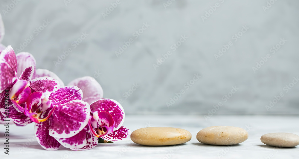 Poster spa still life setting with orchid flower and massage stones