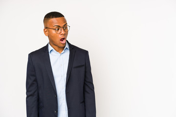 Young business latin man isolated on white background being shocked because of something she has seen.