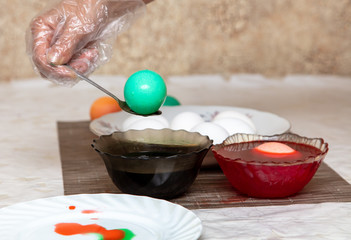 Painting eggs in the kitchen.