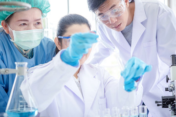 Laboratory research. Team work asian People Scientists analyzing study data and evaluating...