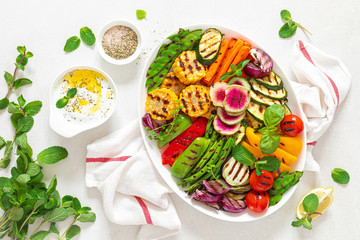 Grilled vegetables on a white plate, top view