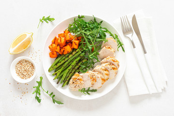 Grilled chicken breast, fillet with butternut squash or pumpkin, green beans and fresh arugula salad, healthy food, top view
