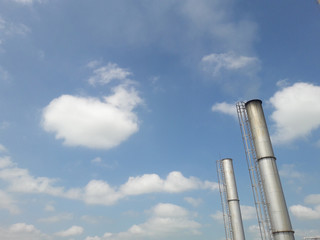 lower view boiler stack in power plant, air pollution concept