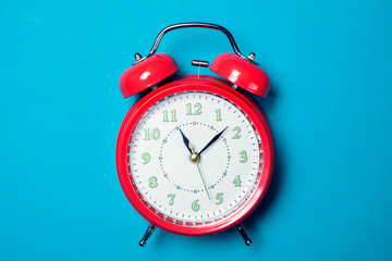 Alarm clock on the color background.