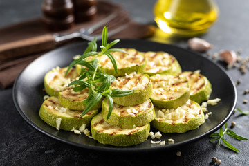 Grilled zucchini, courgette with garlic and rosemary on plate