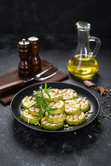 Grilled zucchini, courgette with garlic and rosemary on plate