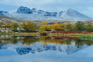 Reflection of Rondslottet mountain in Rondane National park, Norway, Europe