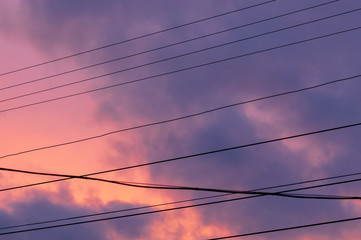 Fototapeta premium Wires against the sky with clouds