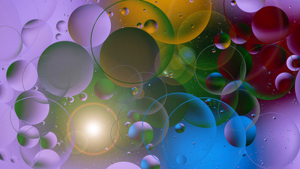 bright oily drops in water with colorful background, close-up 