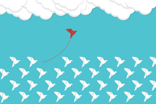 Think differently concept. Be different. Red bird changing direction. New idea, change, trend, courage, creative solution, innovation and unique way concept.	