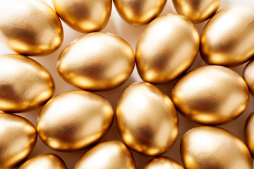 Golden eggs close-up, close to each other. The concept of Easter, abundance, wealth, luxury, a symbol of religion or success.