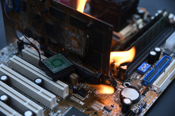 Fire Burning ,blazing computer motherboard, cpu,gpu and video card, processor on circuit board with...