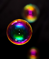 Multicolored soap bubble isolated on a black