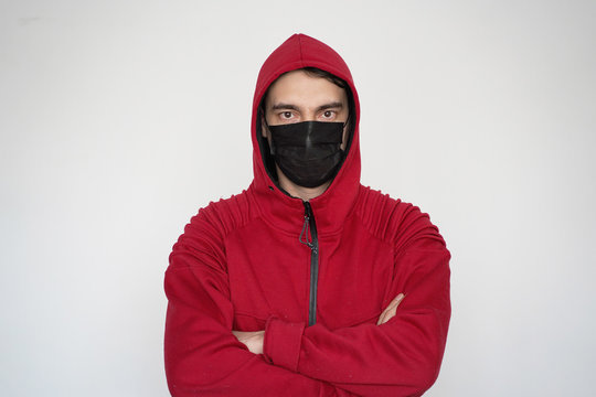 A Man In A Black Medical Mask In Red Clothes On A White Background