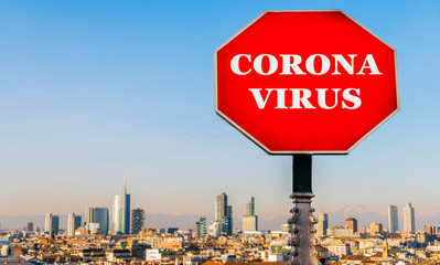 Coronavirus stop sign with Milan, Italy skyline in background