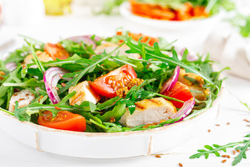 Fresh vegetable salad with grilled chicken fillet, breast, tomato and arugula