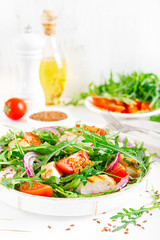 Fresh vegetable salad with grilled chicken fillet, breast, tomato and arugula