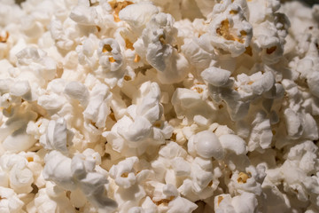 Close up of fresh popcorn with butter under warm lights