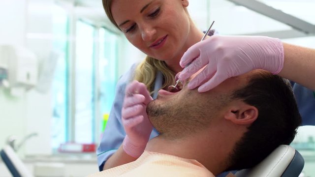 Dentist fixing teeth problems for her patient