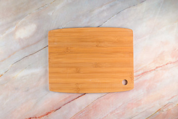 Wooden cutting board on a gray marble background