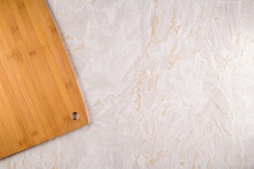 Naklejka na ściany i meble Wooden cutting board on a gray marble background