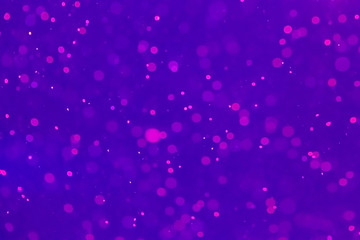 Abstract violet bokeh blurred background with pink defocused lights