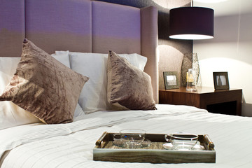 wooden tray and cups on the bed