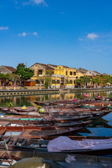Fototapeta na wymiar City view of Hoi an old town with passenger boats