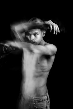 Artistic Dramatic emotional creative portrait of a handsome young naked guy. figurative expression of emotions and feelings. Long exposure creative moody creepy art works. Dancer or fighter