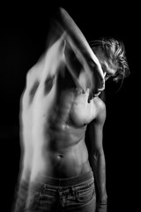 naked torso man handsome young man. abdominal and arm press. looks with reproach. Double personality back and white portrait. Long exposure creative moody creepy art series of works.