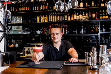 Bartender is making cocktail at bar counter. Fresh cocktails.