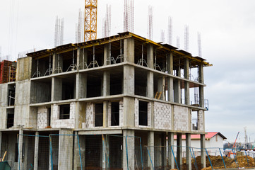 The process of construction and repair of a new modern cement concrete stone pannel monolithic frame-block building of a house with iron reinforcement at an industrial construction site