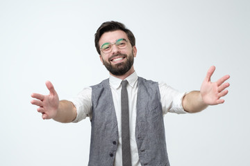 hispanic male wanting to cuddle, smiling broadly, welcoming coworker.