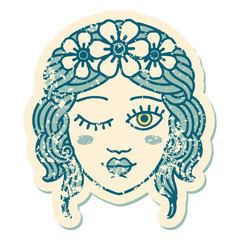 distressed sticker tattoo style icon of a maidens face winking