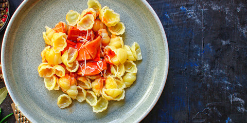 pasta Conchiglie, Orecchiette tomato sauce and sausages (Conchiglioni, ingredients for sauce) menu concept background. top view. copy space